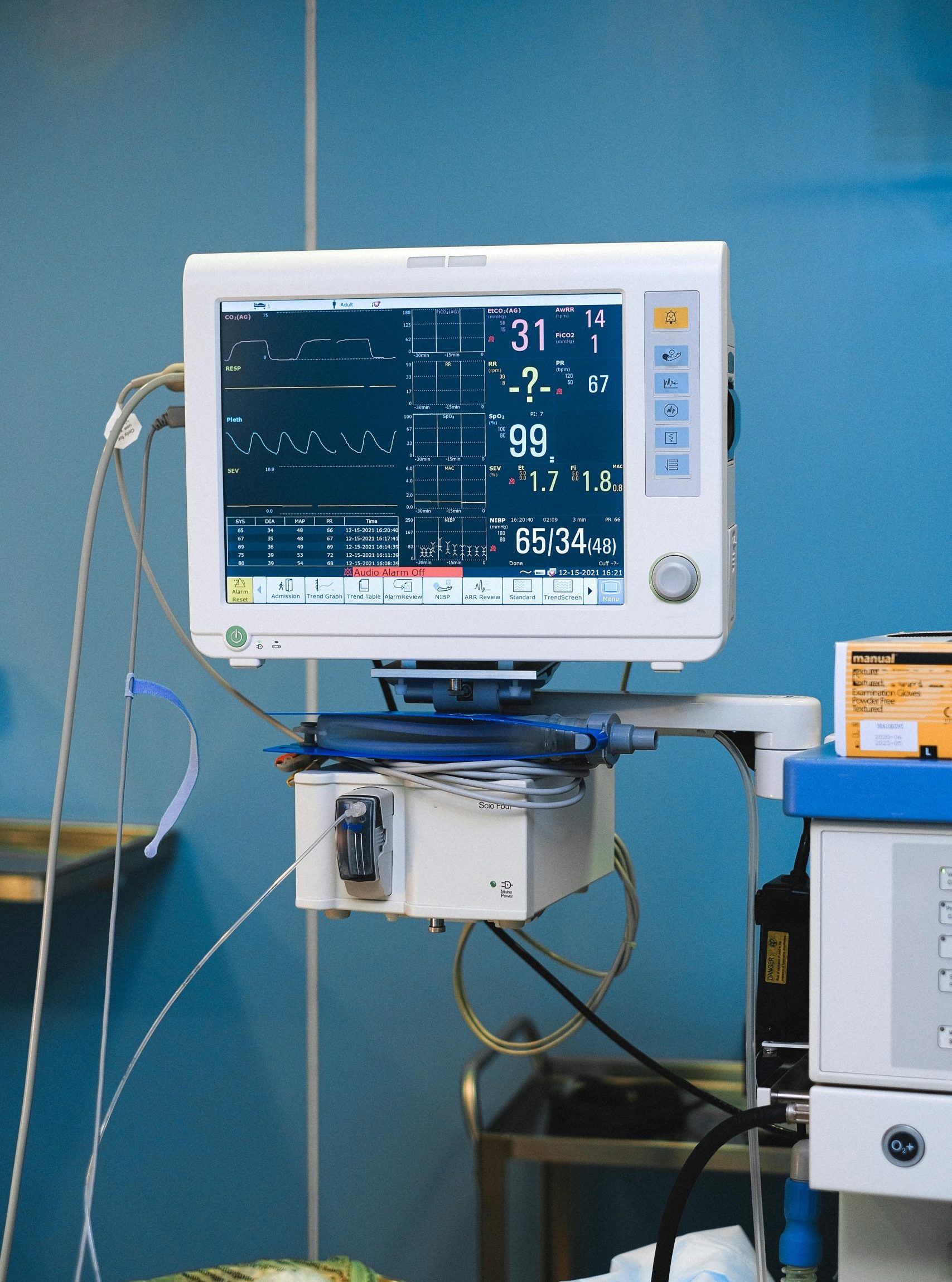 Close-up of a hospital monitor displaying vital signs and heart rate data.
